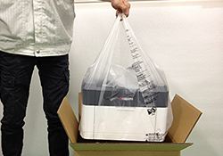 Printer protective bag (a user holds the bag by its handles to lift the printer out the box)
