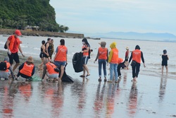 Employees conducting cleanup activity at Do Son Beach